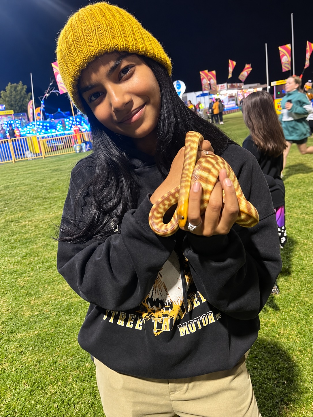 Guest holding a python at a night event